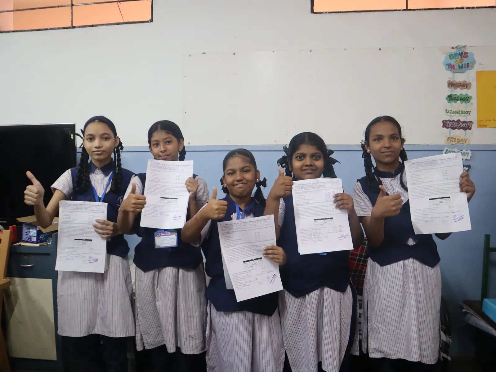 Schoolgirls holding their completed consent and vaccination documents