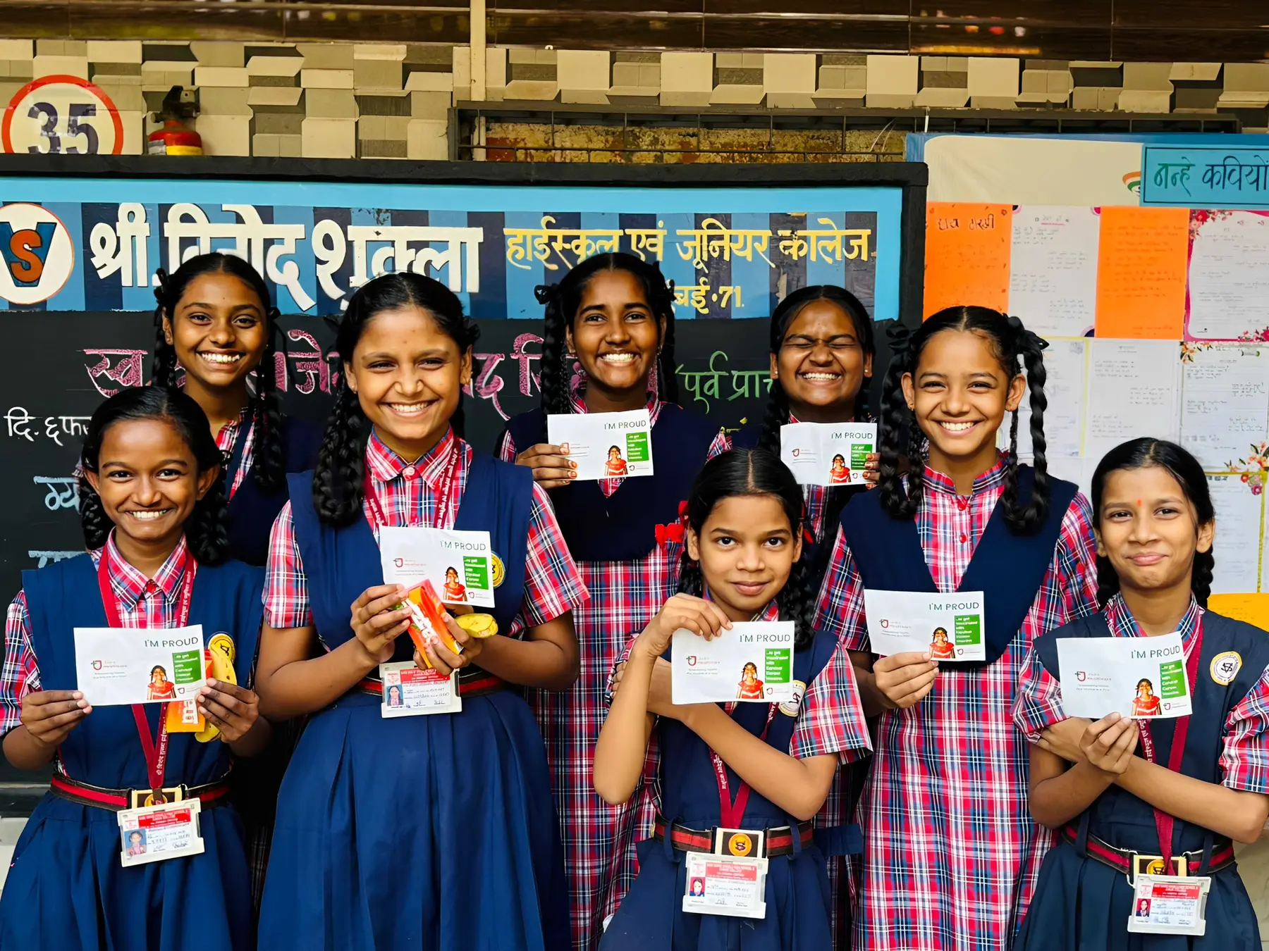 A group of schoolgirls proudly displaying their customised vaccination cards